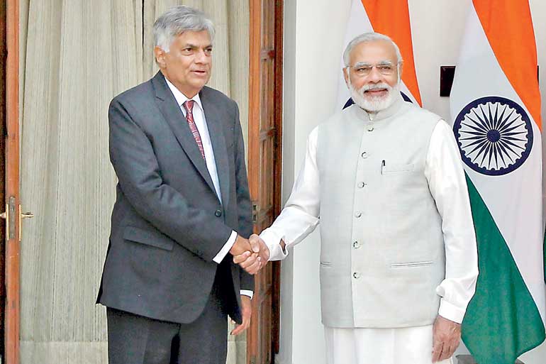 Sri Lanka's Prime Minister Wickremesinghe shakes hands with his Indian counterpart Modi during a photo opportunity in New Delhi