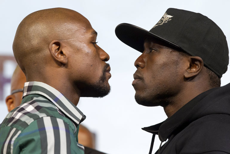 Undefeated WBC/WBA welterweight champion Floyd Mayweather Jr. (L) faces off with challenger Andre Berto during a news conference at MGM Grand Hotel & Casino in Las Vegas