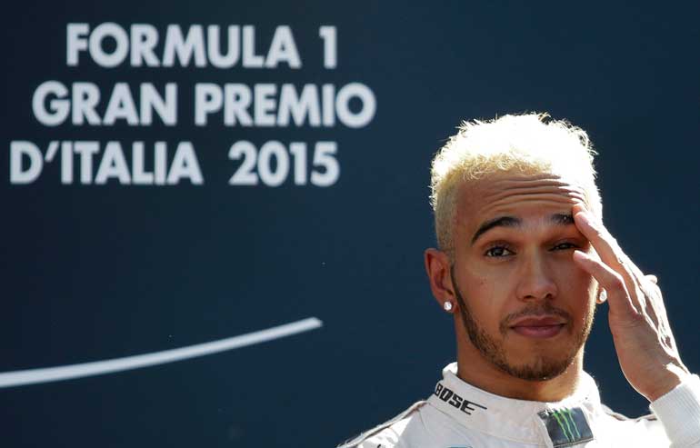 Mercedes Formula One driver Hamilton gestures as he celebrates his victory in the Italian F1 Grand Prix in Monza