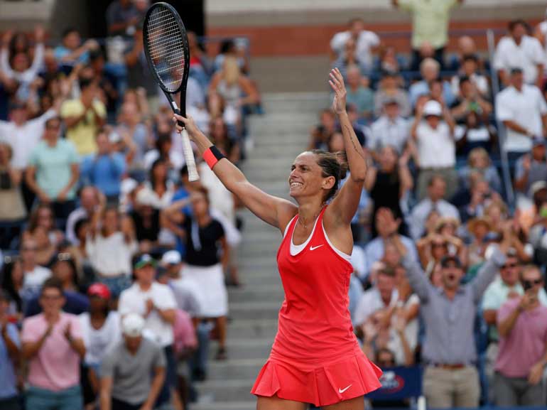 Vinci of Italy reacts after defeating Williams of the U.S. in their women's singles semi-final match at the U.S. Open Championships tennis tournament in New York