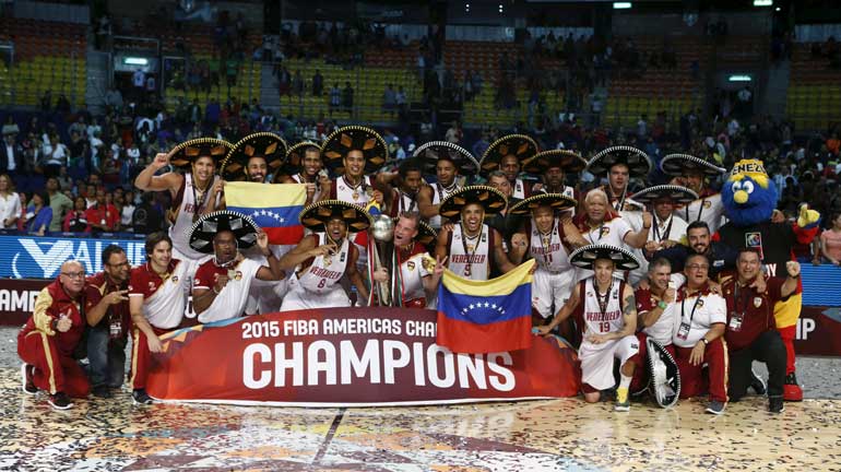 Venezuela's head coach Nestor Garcia and players celebrate with their trophy after defeating Argentina in their 2015 FIBA Americas Championship final basketball game, in Mexico City