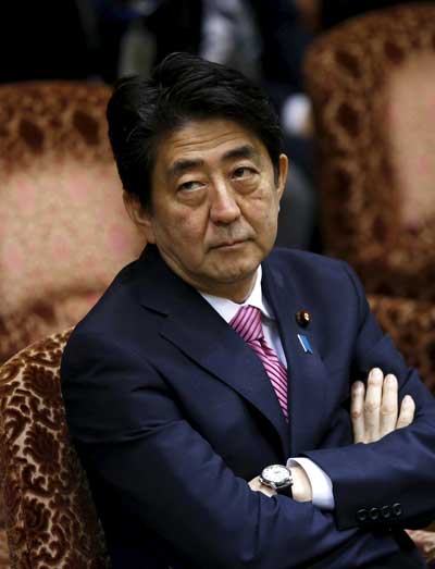 Japan's Prime Minister Shinzo Abe waits for the start of an upper house special committee session for the final debate on security-related legislation at the parliament in Tokyo