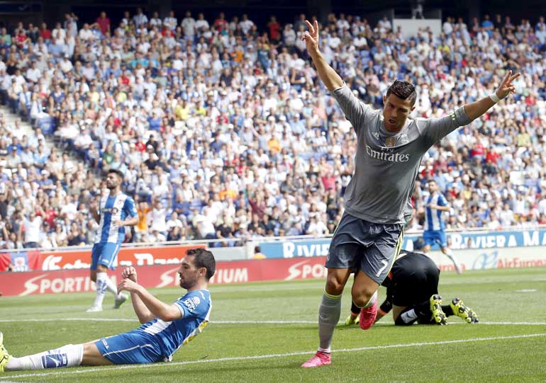 Real Madrid's Cristiano Ronaldo celebrates a goal against Espanyol during their Spanish first division soccer match, near Barcelona, Spain