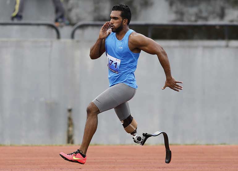 A Sri Lankan army veteran runs during the men's 400m at the Army Para Games in Diyagama