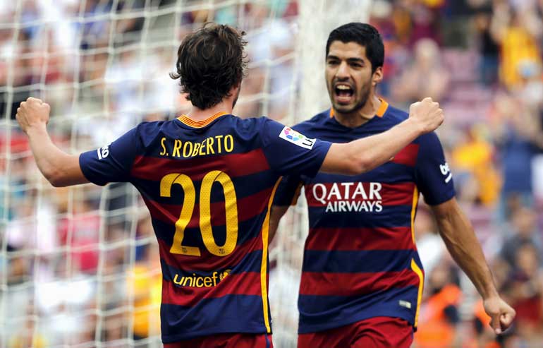 Barcelona's Suarez celebrates team mate Sergi Roberto after scoring a goal against Las Palmas during their Spanish first division soccer match in Barcelona