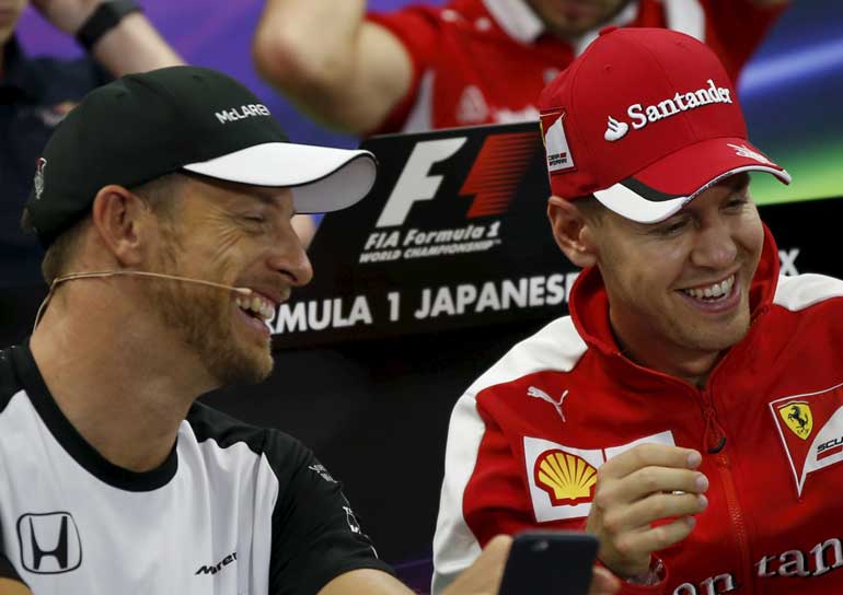 Ferrari Formula One driver Vettel of Germany and McLaren Formula One driver Button of Britain attend a news conference in Suzuka