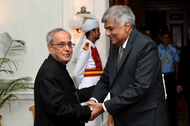Sri Lanka's PM Wickremesinghe shakes hands with Indian President Mukherjee before their meeting in New Delhi