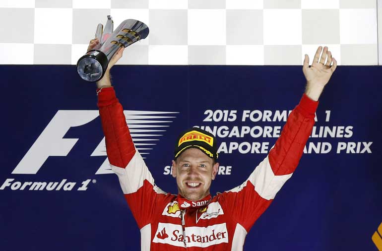 Ferrari Formula One driver Vettel of Germany celebrates on the podium after winning the Singapore F1 Grand Prix