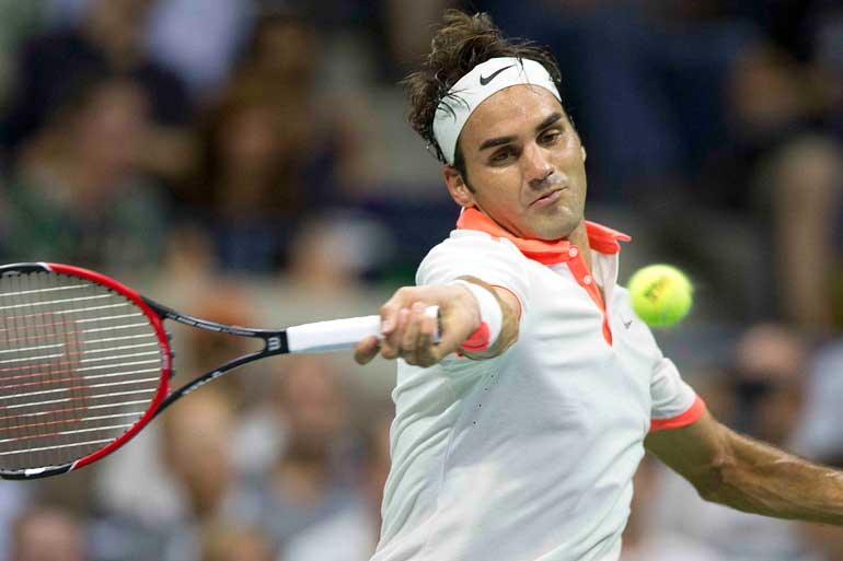 Federer of Switzerland returns a shot to Gasquet of France during their quarterfinals match at the U.S. Open Championships tennis tournament in New York