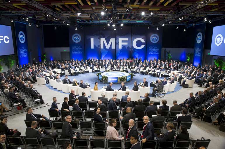 Bank governors and finance ministers pose for a photograph before the start of the International Monetary and Financial Committee (IMFC) meeting during the 2015 IMF/World Bank Annual Meetings in Lima