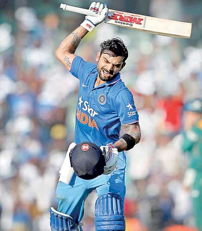 India's Virat Kohli reacts after scoring his century during their fourth one-day international cricket match against South Africa in Chennai