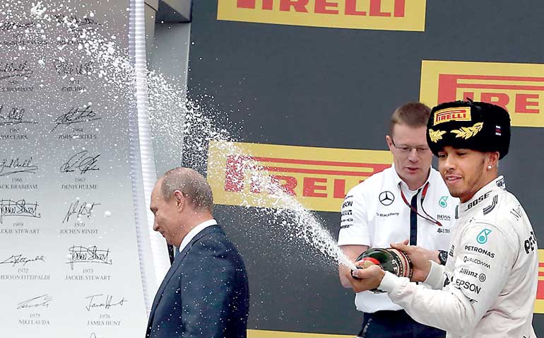 Russian President Putin leaves podium while Mercede's Hamiliron celebrates winning Russian F1 Grand Prix in Sochi