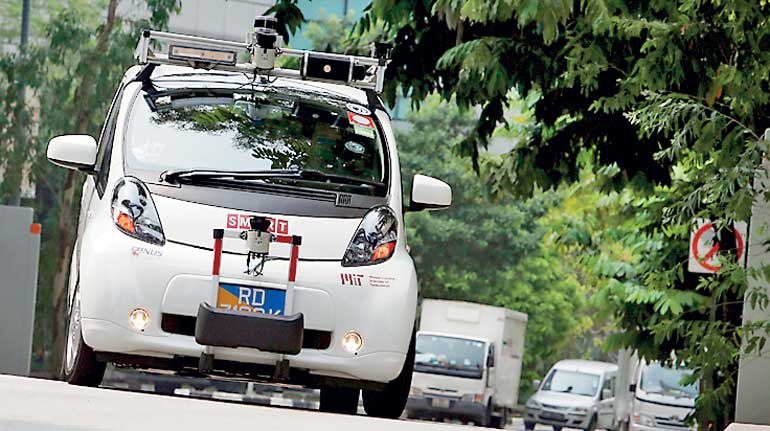 An autonomous self-driving vehicle goes onto the road during a demonstration at one-north business park in Singapore