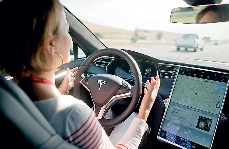New Autopilot features are demonstrated in a Tesla Model S during a Tesla event in Palo Alto, California