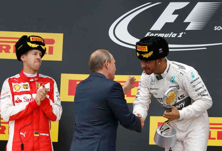 Mercedes' Hamilton is congratulated by Russian President Putin after winning Russian F1 Grand Prix in Sochi