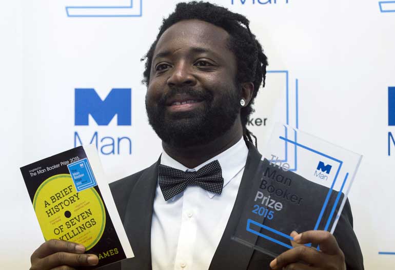 Marlon James, author of "A Brief History of Seven Killings", poses for photographers after winning the Man Booker Prize for Fiction 2015 in London, Britain