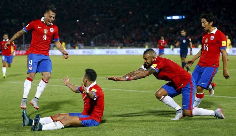 Sanchez of Chile celebrates with team mates Vargas, Vidal and Fernandez after scoring against Brazil during their 2018 World Cup qualifying soccer match in Santiago