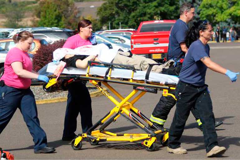 First responders transport an injured person following a shooting incident at Umpqua Community College in Roseburg Oregon