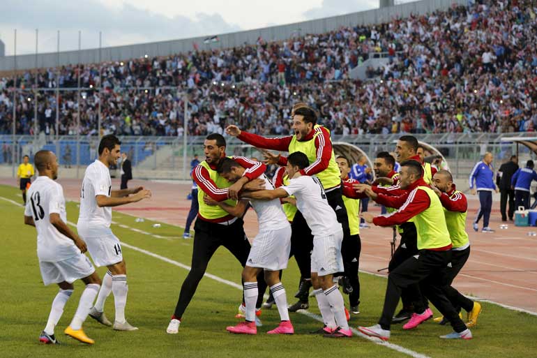 Jordan's players celebrate their goal against Australia during their 2018 World Cup qualifying soccer match at the Amman International Stadium in Amman, Jordan