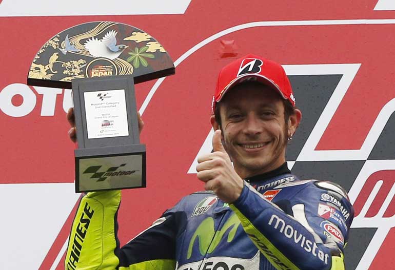 Yamaha MotoGP rider Rossi of Italy raises his trophy on the podium after the Japanese Grand Prix at the Twin Ring Motegi circuit in Motegi