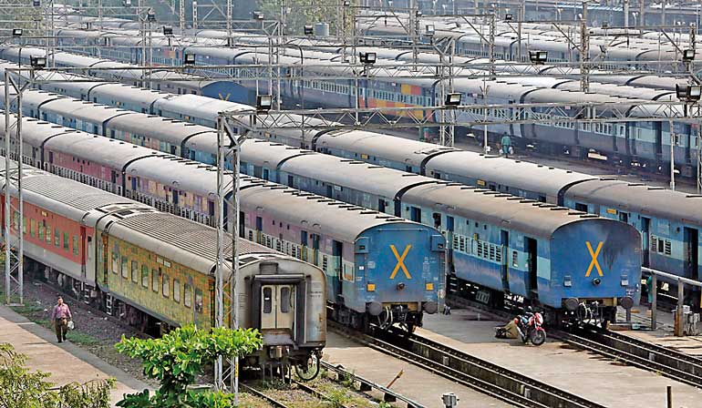 Parked passengers trains are seen at a railway station in Mumbai