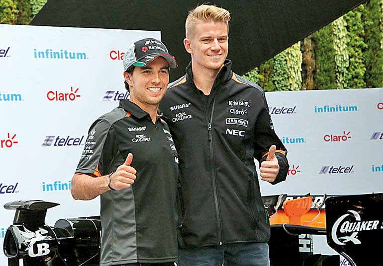 Force India Formula One driver Sergio Perez of Mexico and teammate driver Nico Hulkenberg of Germany poses after they attending a news conference in Mexico City, Mexico