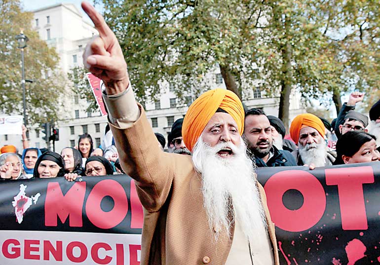 Demontrators protest opposite Downing Street against India's Prime Minister Narendra Modi's official visit, in London