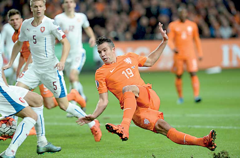 van Persie of the Netherlands falls during the match against Czech Republic during their Euro 2016 group A qualifying soccer match in Amsterdam
