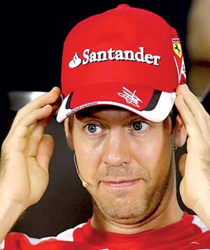 Ferrari Formula One driver Vettel of Germany listens to a question during a news conference for the Brazil F1 Grand Prix in Sao Paulo