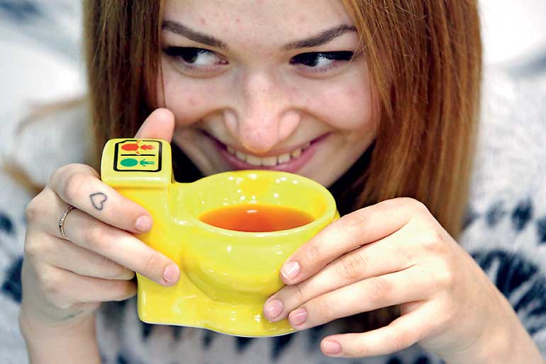 Woman drinks tea at Crazy Toilet Cafe in central Moscow