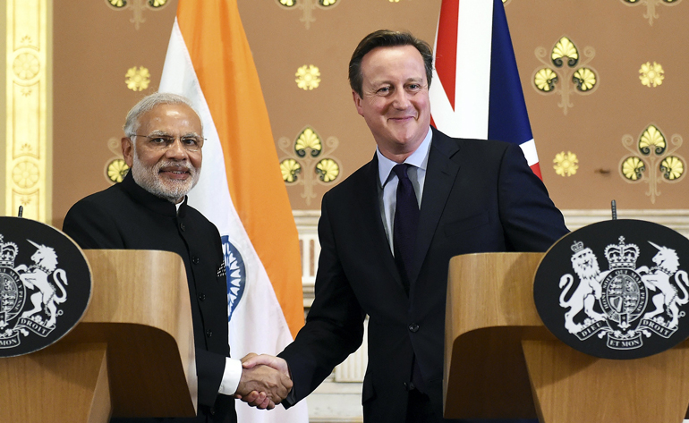 India's Prime Minister Narendra Modi shakes hands with Britain's Prime Minister David Cameron after a joint news conference at the Foreign Office at the start of a three-day official visit in London