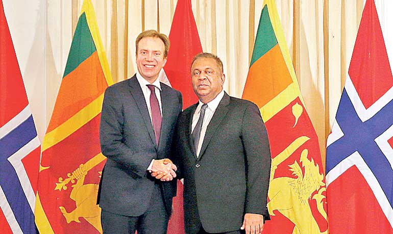 Norway's FM Brende shakes hands with Sri Lanka's FM Samaraweera during their bilateral discussions in Colombo