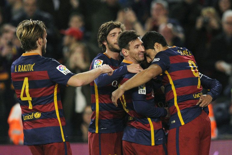 Barcelona's Lionel Messi celebrates with his team mates his first goal