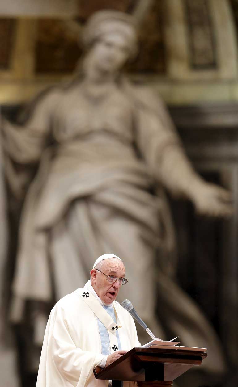 Pope Francis speaks during a mass on New Year's Day at Saint Peter's Basilica at the Vatican
