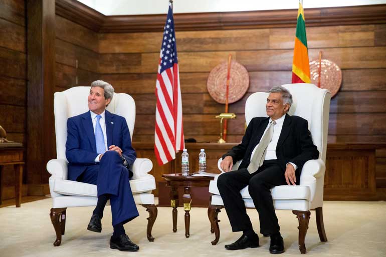 U.S. Secretary of State Kerry sits next to Sri Lankan Prime Minister Wickremesinghe before a meeting at the Prime Minister's residence in Colombo