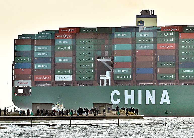 File picture of onlookers watching as the largest container ship in world docks during its maiden voyage at the port of Felixstowe in south east England