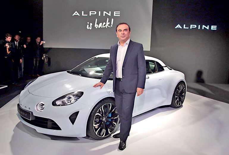 Carlos Ghosn, Chairman and CEO of the Renault-Nissan Alliance,  poses near the Renault's new Alpine sports concept car " Vision" unveiled in Monaco
