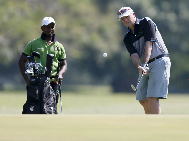 New Zealand's Prime Minister Key hits a ball during a golf session at Colombo Golf Club during his three-day visit in Sri Lanka