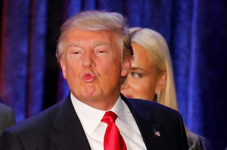 Republican U.S. presidential candidate Donald Trump makes a face at his caucus night rally in Des Moines