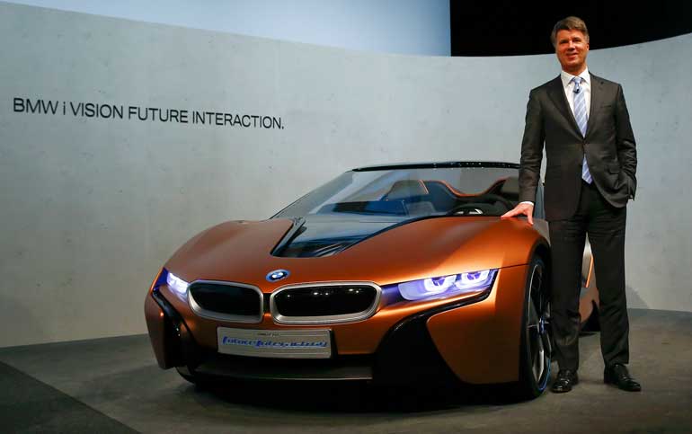 Krueger, Chief Executive of German luxury carmaker BMW poses next to a BMW i vision after a news conference in Munich