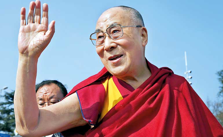 Tibetan spiritual leader the Dalai Lama waves to devotees outside the United Nations in Geneva