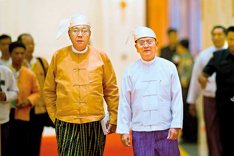 New Myanmar President Htin Kyaw and outgoing president Thein Sein arrive for the  handover ceremony at the presidential palace in Naypyitaw