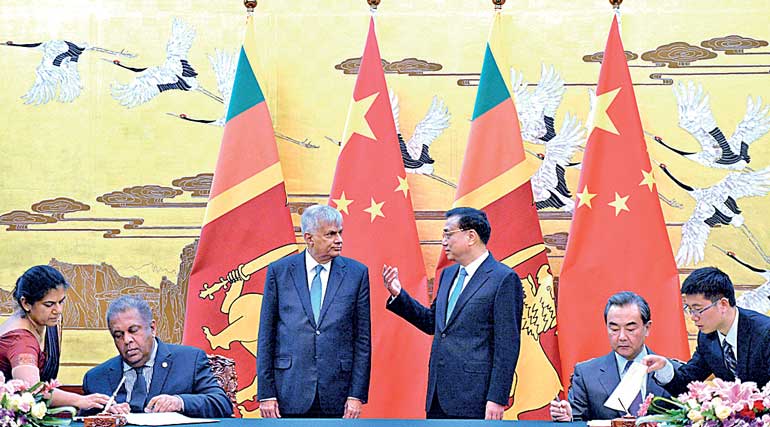 Sri Lankan Prime Minister, Ranil Wickremesinghe and Chinese Premier, Li Keqiang talk during a meeting at the Great Hall of the People in Beijing