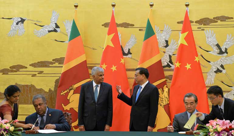 Sri Lankan Prime Minister, Ranil Wickremesinghe and Chinese Premier, Li Keqiang talk during a meeting at the Great Hall of the People in Beijing