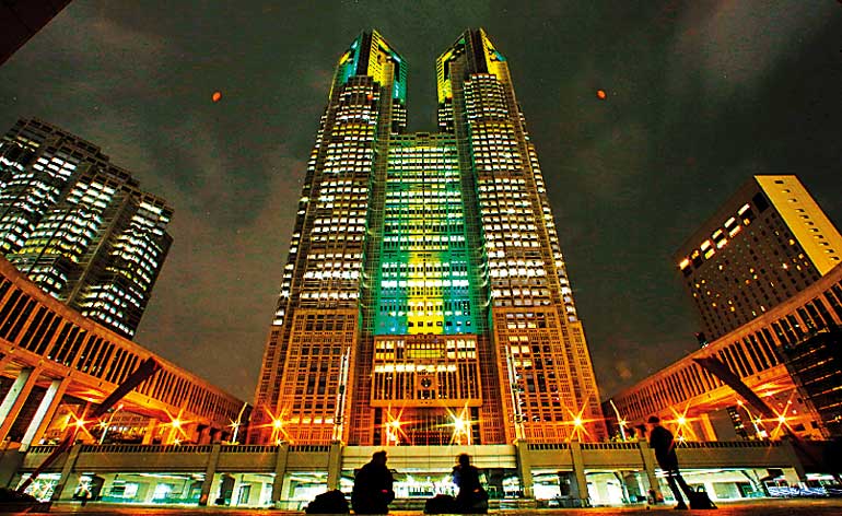 The Tokyo Municipal Government Headquarters are pictured lit in the yellow and green colours of Brazil's flag in celebration of the 100 days before the 2016 Rio Olympics in Tokyo