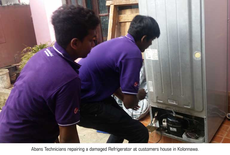 Abans-technicians-repairing-a-damaged-refrigerator-at-customer's-house-in-Kolonnawa
