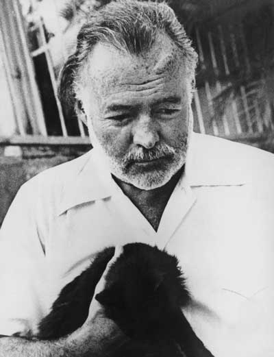 1-American-novelist-and-journalist-Ernest-Hemingway-(1899-1961)-with-his-pet-cat,-circa-1950
