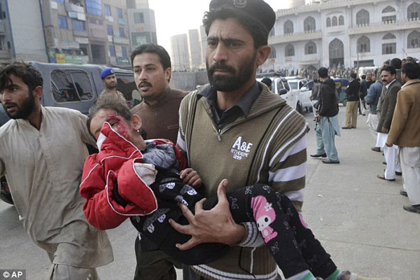 24173C8800000578-2875729-A_Pakistani_girl_who_was_injured_in_the_attack_is_rushed_to_a_ho-a-41_1418838309275