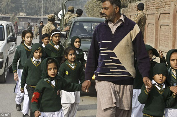 24174F0D00000578-2875729-A_plainclothes_security_officer_escorts_students_rescued_from_a_-a-55_1418838309833