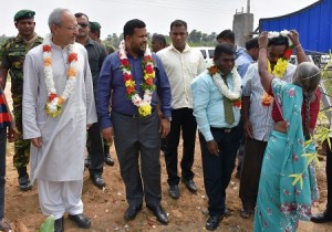 Minister for Commerce Rishad Bathiudeen and High Commissioner Syed Shakeel Hussain being greeted by a local family